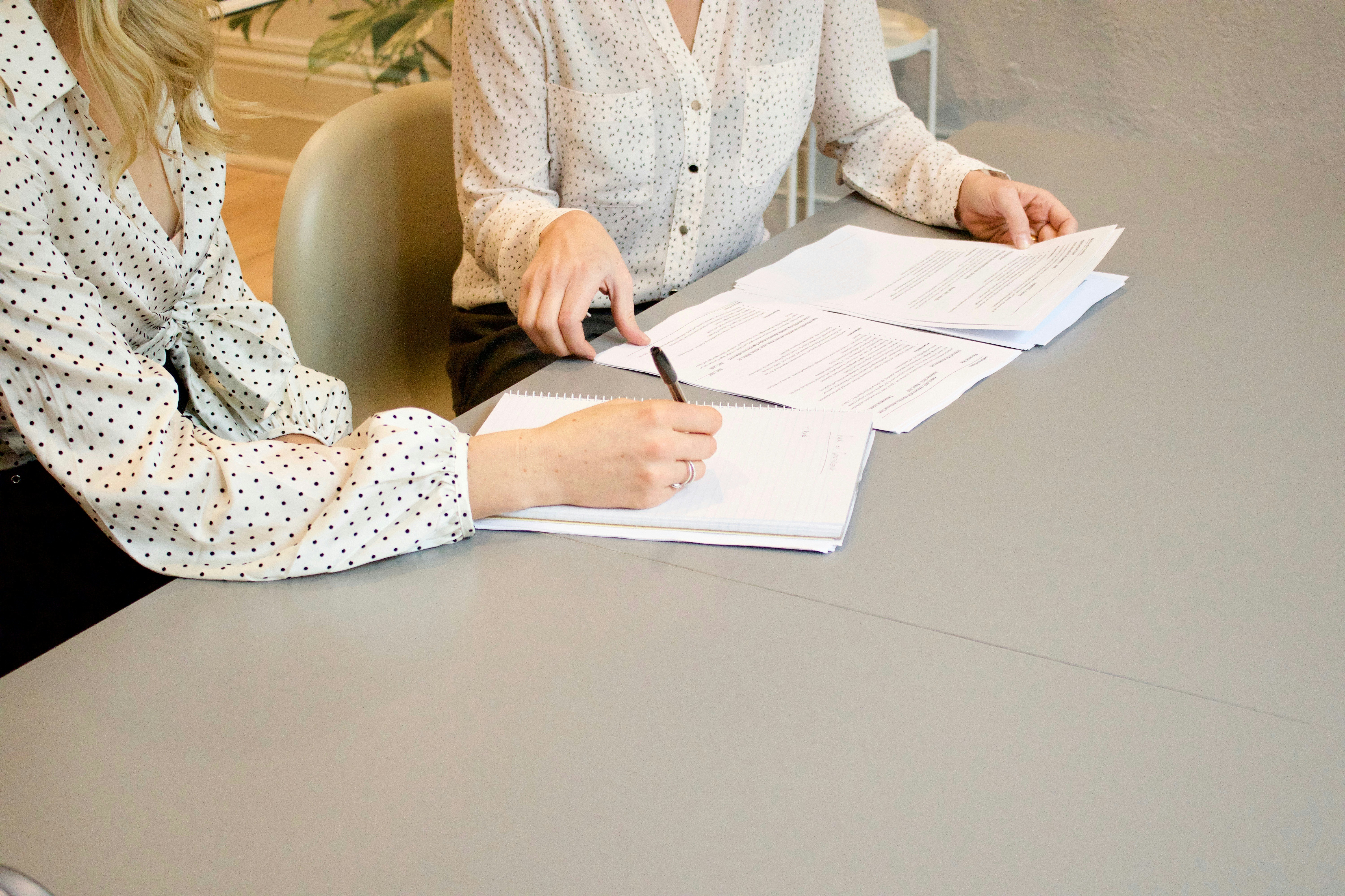 office desk and lady reviewing papers